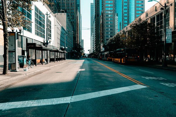 A quiet street with modern buildings and buses in traffic in Seattle, Washington, USA
