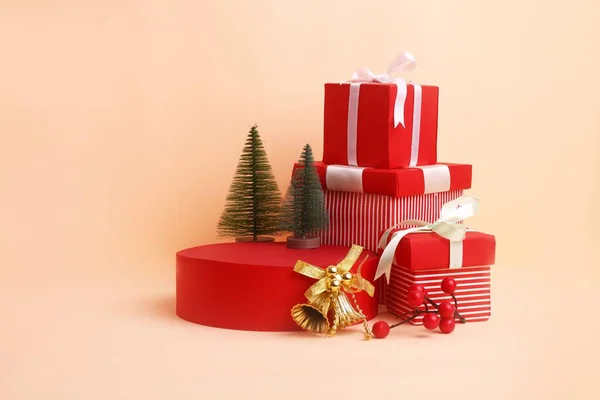 stock image A studio shot of red gift boxes, Christmas trees and golden bells for a background usage