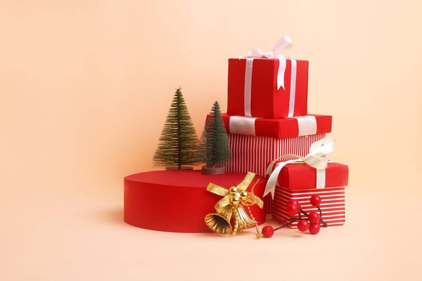 A studio shot of red gift boxes, Christmas trees and golden bells for a background usage