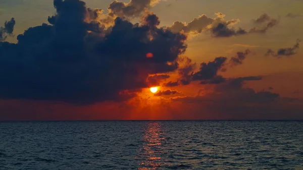 stock image A scenic shot of the sun reflecting its golden light on the surface of a calm sea