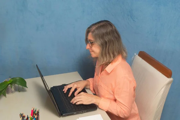 A female with laptop computer working from home or office