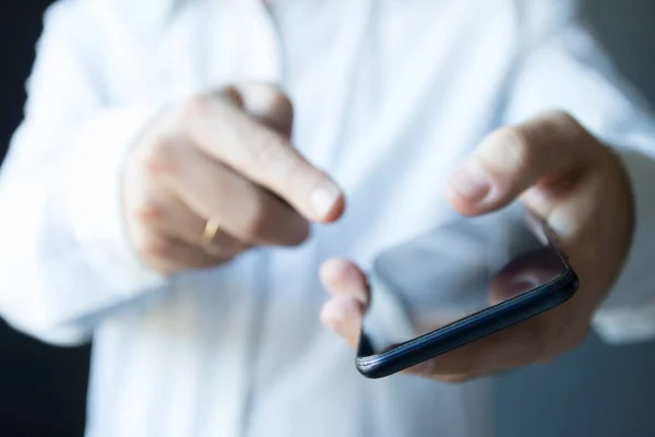 stock image A man pointing out his finger to the blank screen of the modern smartphone