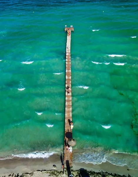 Vertical Shot Wooden Pear Sandy Beach Blue Color Sea Sunshade — Stock Photo, Image