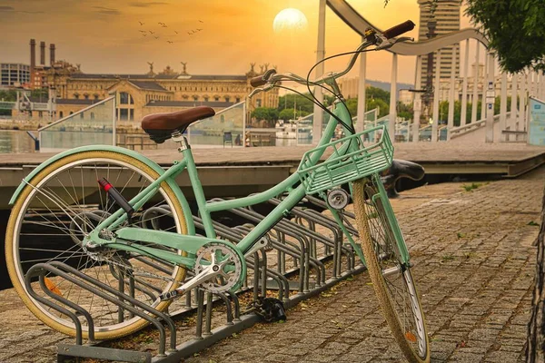 一辆旧式漂亮的绿色自行车停在一座城市的架子上 — 图库照片