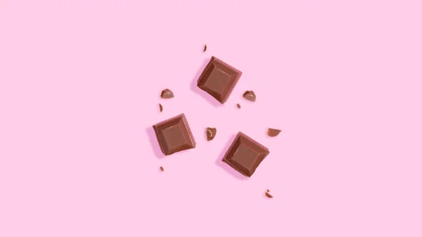 Una Vista Dall Alto Pezzi Cioccolato Uno Sfondo Rosa — Foto Stock