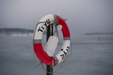 A closeup shot of Tryg saving ring near the lake in Sandvik, Norway clipart