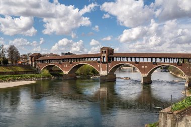 Pavia, Lombardy, İtalya 'daki Ticino nehri üzerindeki tarihi Ponte Koperto Köprüsü' nün güzel bir görüntüsü.