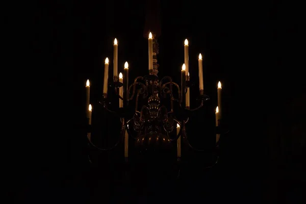 在黑暗中点着蜡烛的吊灯的特写镜头 — 图库照片