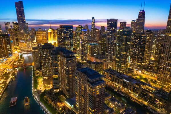 An aerial Chicago skyline with golden lights at sunset