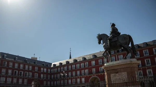 The Plaza Mayor and a statue in a public space in the heart of Madrid, Spain
