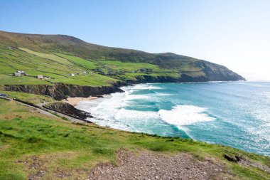 A beautiful view of the Coumeenoole Beach under a blue sky in County Kerry, Ireland clipart