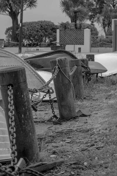 boats chained to a fence awaiting use