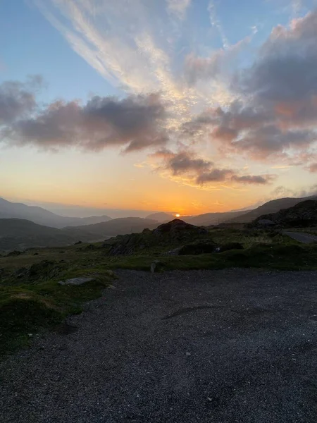 Вертикальний Знімок Хмарного Неба Заходу Сонця Над Силуетними Горами — стокове фото