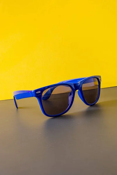 Blue Dark Plastic Sunglasses Yellow Background — Stock Photo, Image