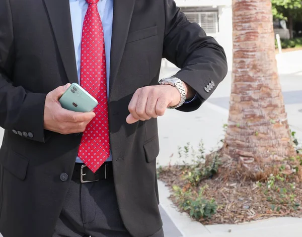 Male Black Suit Holding Iphone Looking Time Hand Watch — Stock Photo, Image