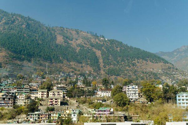Scenic view of Jtown surrounded by mountains with blue sky background