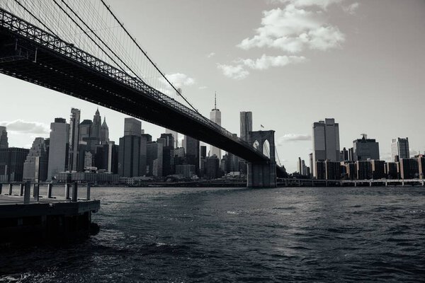 The Brooklyn Bridge on a sunny day, grayscale