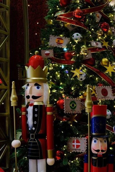 Vertical Shot Nutcracker Character Front Christmas Tree National Flags Countries — Stock Photo, Image