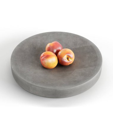 Beyaz arka planda izole edilmiş modern gri bir tepside üç nektarin yakın çekimi.