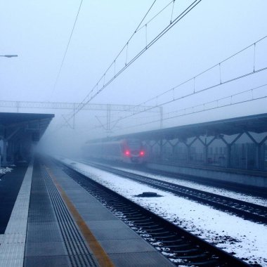 Sisli bir alanda raylardan gelen bir tren.