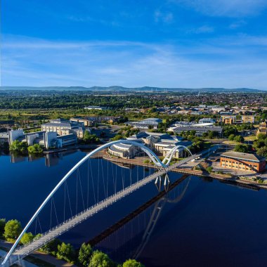 Aerial view of the Infinity Bridge spanning the river Tees located in Stockton on tees, North East England with the Cleveland Hills in the background clipart
