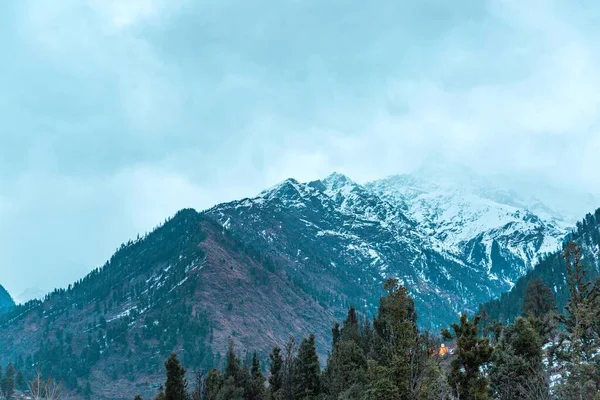 stock image An aerial view of snow covered mountain landscape surrounded by dense trees