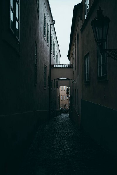 A vertical shot of a narrow street in the evening