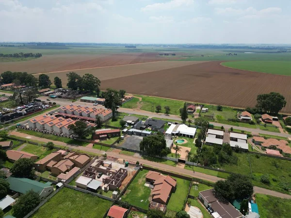 stock image An aerial view of a residential area with vast agricultural lands in the background