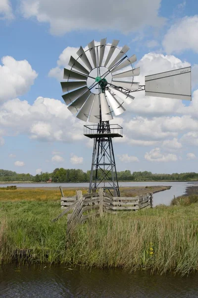 Old Metal Windmill Grass Lawn River Blue Cloudy Sky — Stock Photo, Image