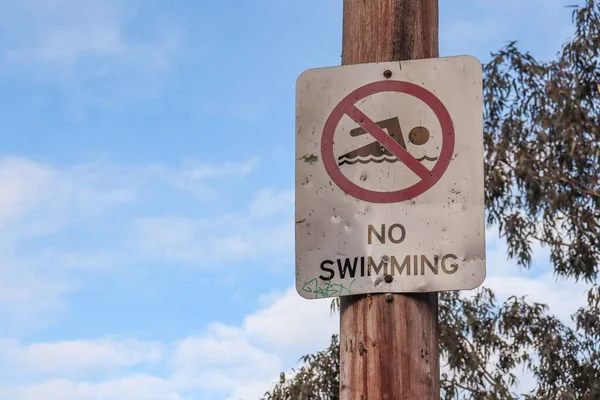 Swimming Sign Wooden Pole Sky Leaves Background Concept Caution — Stock Photo, Image