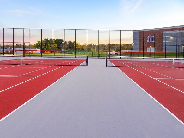 Amazing new red tennis court with white lines combined with gray pickleball lines