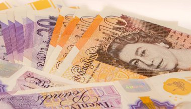 Beyaz arkaplana karşı 10 pound 'luk banknot yığını