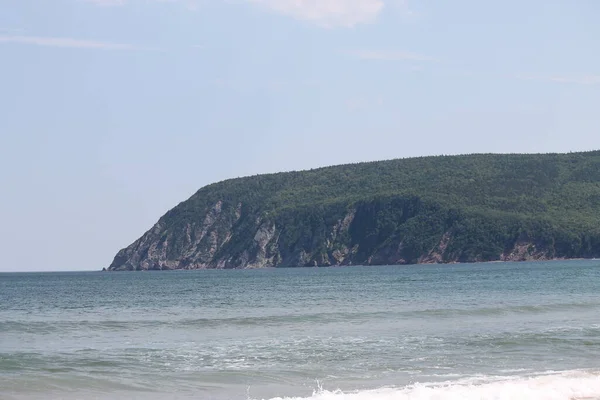 stock image A scenic seascape with mountains on the background