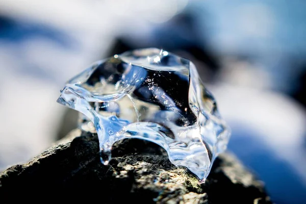 Bulanık Bir Arkaplanda Kayanın Üzerinde Güzel Bir Buz Parçasının Yakın — Stok fotoğraf