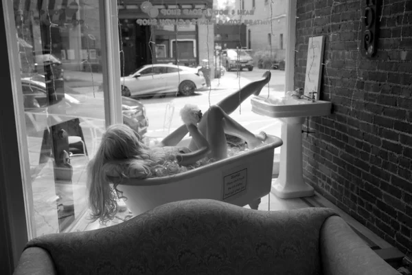 在小城镇的一家百货商店里 一个人体模特正在洗澡的灰白照片 — 图库照片