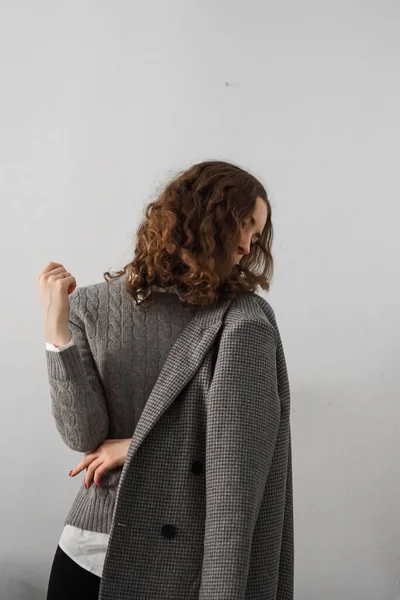 stock image A Caucasian woman wearing gray coat posing in white background