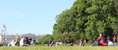 Sankt Petersburg Rusya 'sındaki bir parkta güneşli bir günün tadını çıkaran insanların panoramik görüntüsü