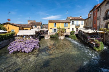 İtalya, Veneto 'da Borghetto sul Mincio' nun renkli köyünde tipik bir restoran.