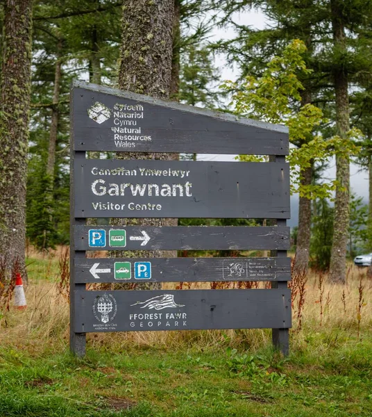 stock image A vertical shot of a visitor center sign at Garwnant in the Brecon Beacons in the woods