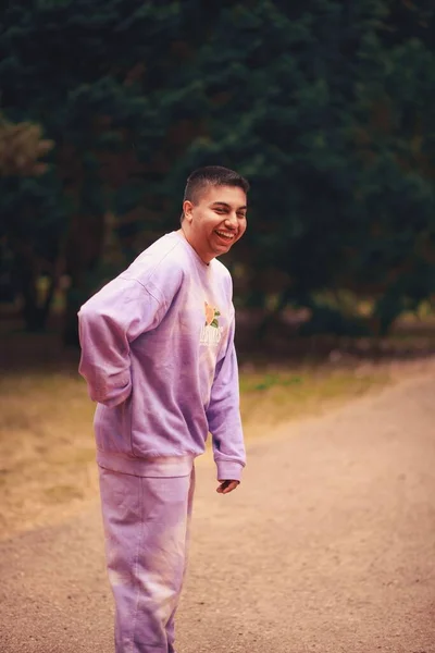 公園の紫のネクタイ染めのスポーツ衣装で幸せなヒスパニック系の男の垂直ショット — ストック写真