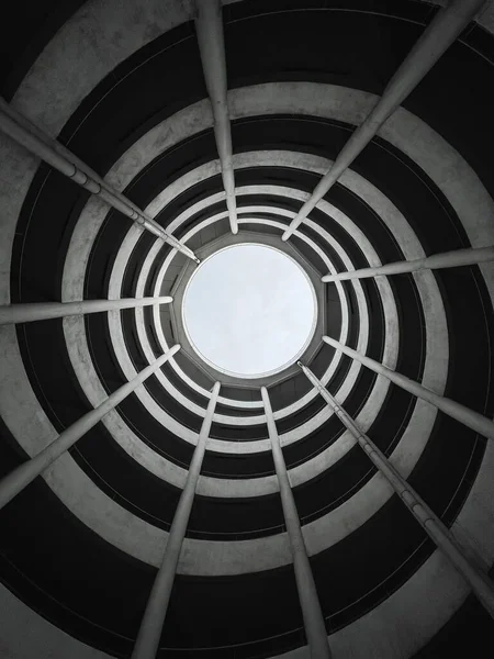 stock image A low angle view of the ceiling of a building from inside with a spiraling pattern and a hole allowing sunlight through