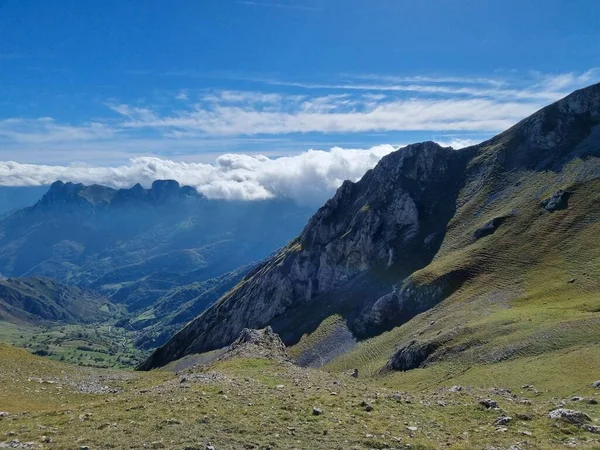 スペインのアストゥリアス州に雲が立ち並ぶ青い空の下の緑の丘の美しい風景 — ストック写真