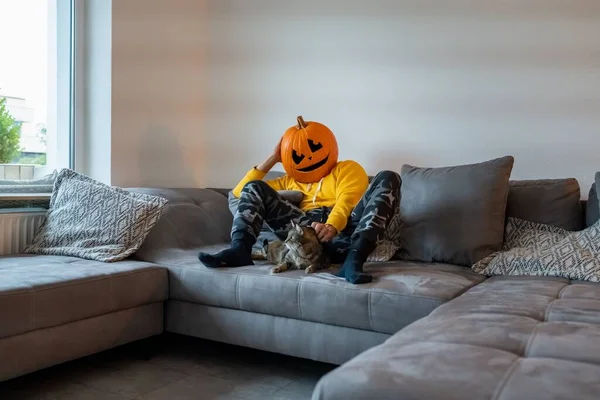 Young Man Wearing Scary Pumpkin Head Sitting Couch His Cat — Stock Photo, Image