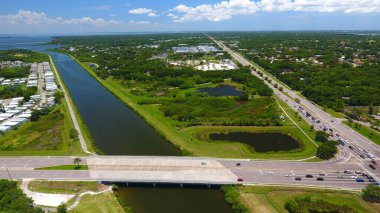 A drone shot of a river flowing to the Lake Tarpon Canal and the Oldsmar Trail Head in Florida, USA clipart