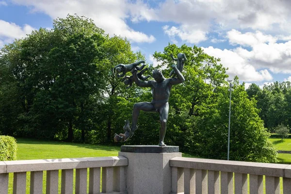 stock image A modern sculpture in the Vigeland park in Oslo, Norway captured against the leafy trees and blue sky