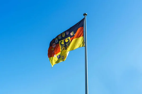 stock image The german Federal states flag waving against a blue sky