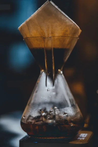 stock image A vertical shot of a Cup Glass Handle with a tea packet on it and steam in it