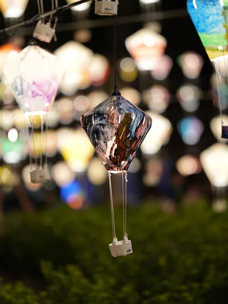 stock image A vertical shot of decorative hot air balloon lanterns illuminated at night