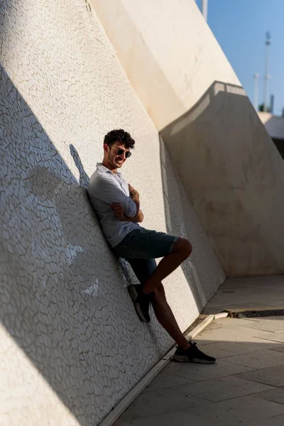 Pionowe Ujęcie Młodego Wenezuelczyka Swobodnym Stylu Pozującego Szczęśliwie Plecami Ściany — Zdjęcie stockowe