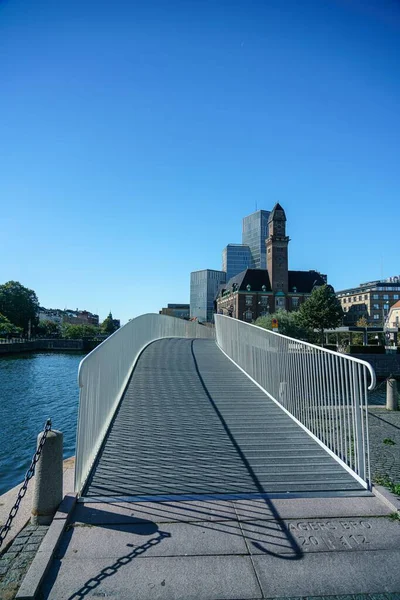 stock image A vertical shot of a designed modern walkway bridge over water in Malmo, Sweden